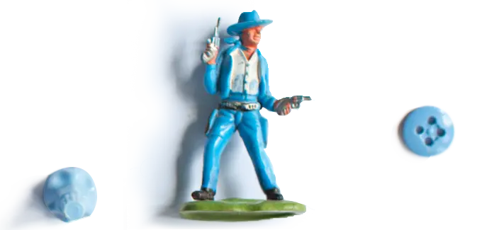 Toy figure of a cowboy wearing a blue suit and blue hat