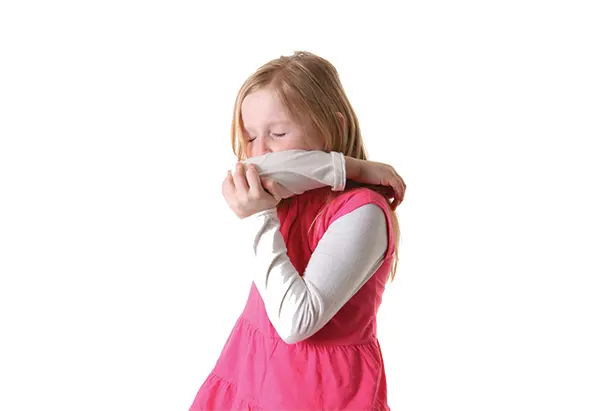 Child sneezing into their elbow