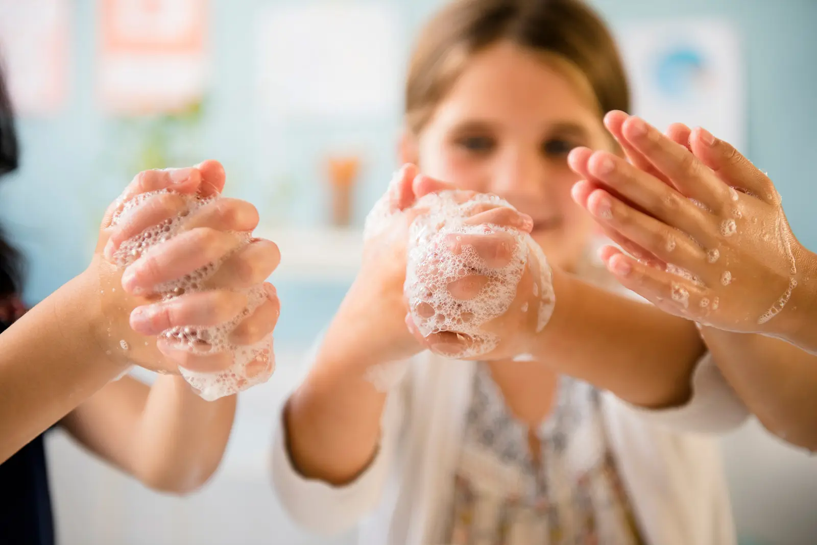 Three children lathering hands with soap