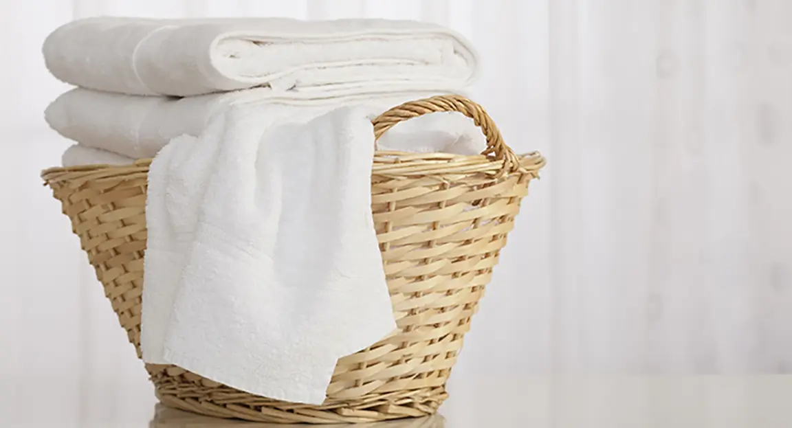 How to Sanitize Laundry Straw laundry basked filled with clean white towels