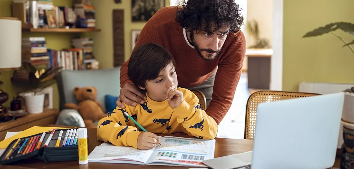Resources for Teaching at Home Close up of a father helping his son with schoolwork in their home