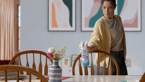 Coach standing with whistle and 5$ trial size lysol laundry sanitizer