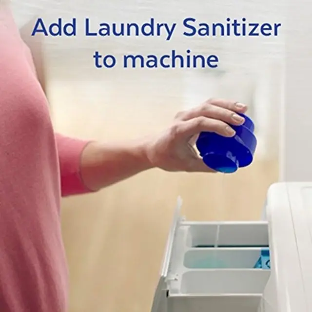 The dosing cup being used to dispense Laundry Sanitizer into the fabric softener compartment of the machine.