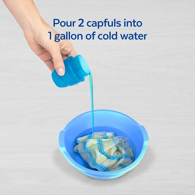 Laundry sanitizer being poured into a bowl containing fabric and water. Text says "pour 2 capfuls into 1 gallon of cold water".