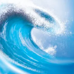 A large ocean wave with sea foam on top.